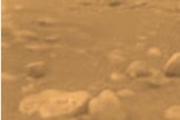 The Huygens probe took this photo from the surface of Titan. The image has been colored and processed to give a good indication of the actual orangeish color of the surface.