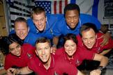 This image of the STS-107 crew in orbit was recovered from wreckage inside an undeveloped film canister. The shirt color's indicate their mission shifts. From left (bottom row): Kalpana Chawla, mission specialist; Rick Husband, commander; Laurel Clark, mission specialist; and Ilan Ramon, payload specialist. From left (top row) are astronauts David Brown, mission specialist; William McCool, pilot; and Michael Anderson, payload commander. Ramon represents the Israeli Space Agency.