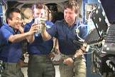 The Expedition 19 crew participates in a toast aboard the International Space Station.