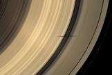 The shadow of Saturn's moon Mimas dips onto the planet's rings and straddles the Cassini Division in this natural color image taken as Saturn approaches its August 2009 equinox.
