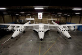 Virgin Galactic released this sneak peak of the new SpaceShipTwo suborbital spaceliner (center) attached to its carrier aircraft just ahead of their Dec. 7, 2009 unveiling.