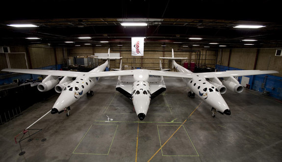 Virgin Galactic released this sneak peak of the new SpaceShipTwo suborbital spaceliner (center) attached to its carrier aircraft just ahead of their Dec. 7, 2009 unveiling.