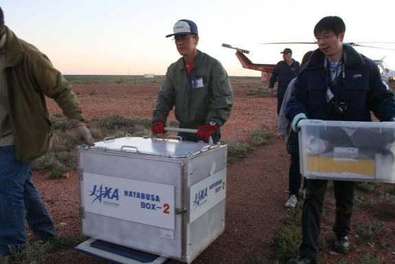 The sample return capsule (inside a box) from Japan's Hayabusa asteroid probe is transported by helicopter to the Instrumentation Building inside the Woomera Test Range after its June 13, 2010 landing. The re-entry capsule was housed in a temporary clean room before being returned to Japan on Tuesday. <a href=http://www.space.com/missionlaunches/japan-hayabusa-asteroid-probe-return-100614.html>Full Story</a>.