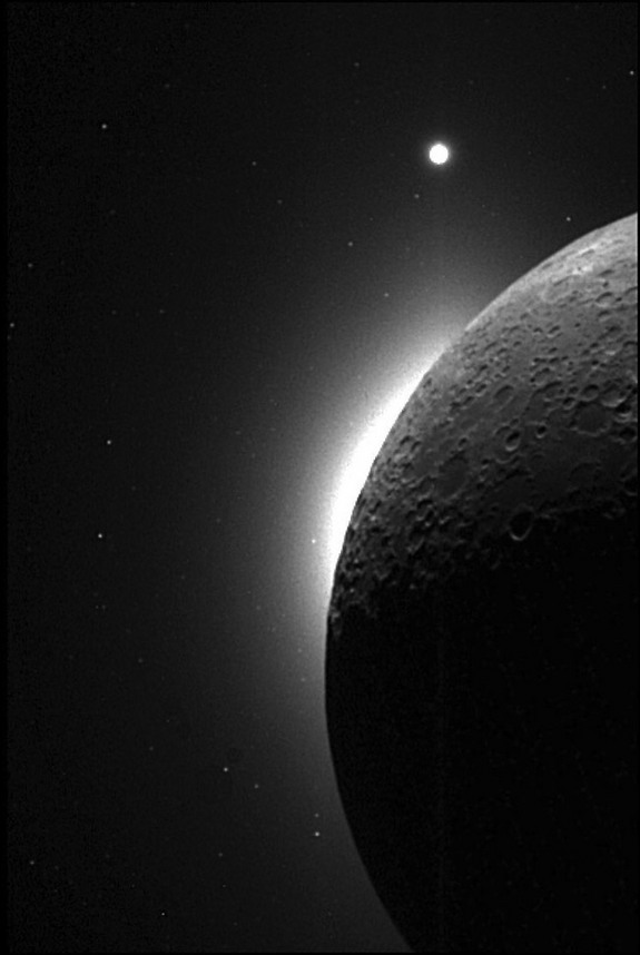 The slim, bright crescent, known as the Lunar Horizon Glow (LHG) was glimpsed several times during Apollo missions. This picture was taken with the Clementine spacecraft, when the sun was behind the moon. The white area on the edge of the moon is the LHG, and the bright dot at the top is the planet Venus.