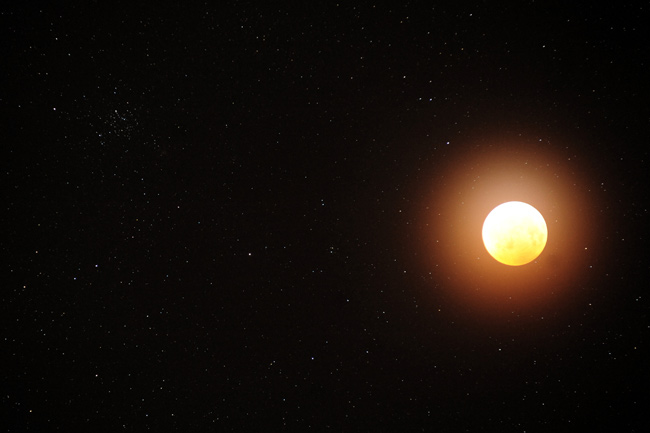 Lunar Eclipse and Star Cluster