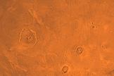 A view of Mars' three large Tharsis Montes volcanoes, which lie in a straight line. Olympus Mons, the largest known volcano in the solar system, is at upper left.