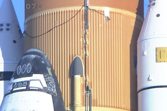 Space shuttle Discovery stands on the launch pad at NASA's Kennedy Space Center Friday morning as a tanking test begins. The wires in this image lead to some of the 89 strain gauges and thermocouples installed on the external tank for the test.