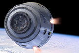 An artist's illustration of SpaceX's Dragon space capsule in Earth orbit.