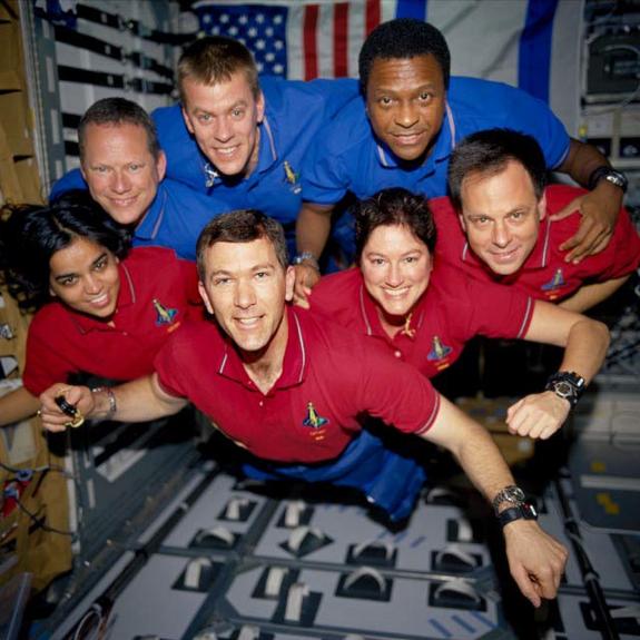 This image of the STS-107 shuttle Columbia crew in orbit was recovered from wreckage inside an undeveloped film canister. The shirt colors indicate their mission shifts. From left (bottom row): Kalpana Chawla, mission specialist; Rick Husband, commander; Laurel Clark, mission specialist; and Ilan Ramon, payload specialist. From left (top row) are astronauts David Brown, mission specialist; William McCool, pilot; and Michael Anderson, payload commander. Ramon represents the Israeli Space Agency.