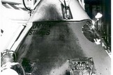 This photograph shows Apollo 1's Command Module a day after the fire that took the lives of astronauts Lt. Col. Virgil "Gus" Ivan Grissom, Lt. Col. Edward Higgins White II, and Lt. Cdr. Roger Bruce Chaffee. The Command Module was taken to the White Room at Launch Complex 34. The intense heat of the flash fire has clearly affected the exterior.