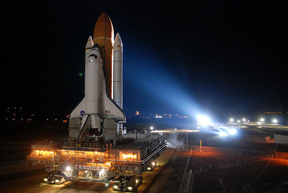 Space shuttle Discovery, bathed in Xenon lights, rolls out to Kennedy Space Center's Launch Pad 39A on Jan. 31, 2011.