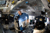 Astronaut Mark Kelly takes a moment for a photo near the commander's station on the forward flight deck of Space Shuttle Discovery during the STS-124 mission.
