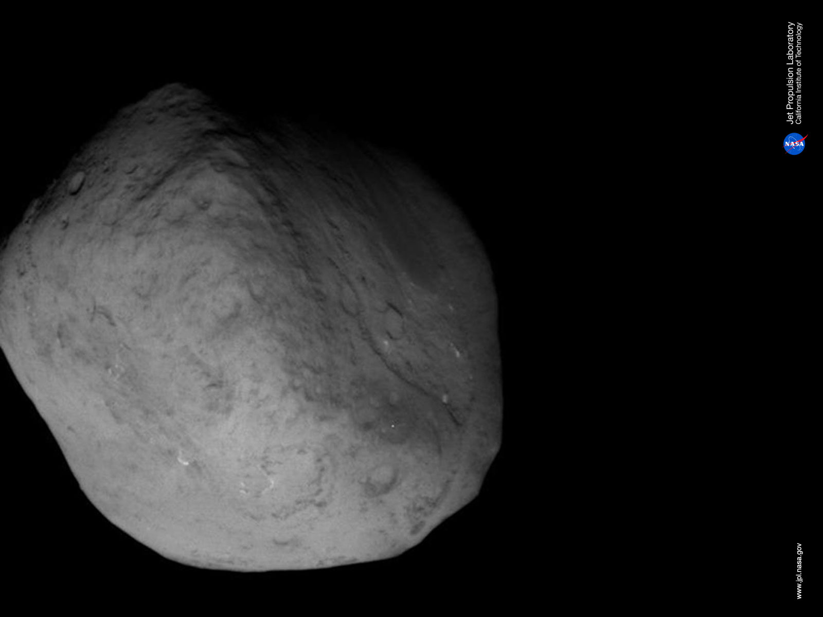 Comet Tempel 1 wallpaper photo from NASA's Stardust spacecraft flyby on Feb. 13, 2011.