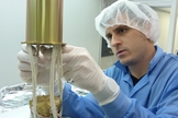Michael Passaretti assembles the Glory spacecraft's twist capsule in Honeybee Robotics' New York City cleanroom.