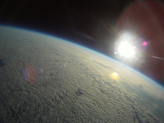 A shot by the Robonaut-1 balloon, looking down at Earth from the edge of space.