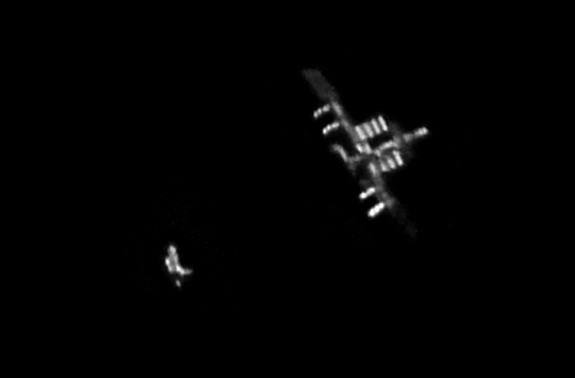 Skywatcher Rob Bullen of Forest of Dean, Gloucestershire, England caught this snapshot of shuttle Discovery (left) as it approached the International Space Staiton on Feb. 26, 2011. Discovery was flying its final mission, STS-133.