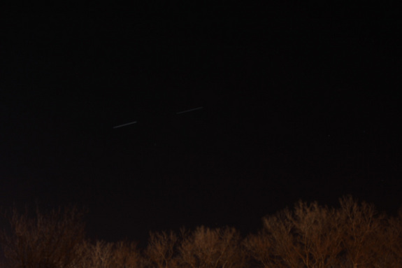 Amateur astronomer Tony Hoffman of New York City took this long-exposure photo of the shuttle Discovery (right light line) and International Space Station as they flew over Flushing Meadows Park in Queens, NY on March 7, 2011 during the STS-133 mission, Discovery's last flight.