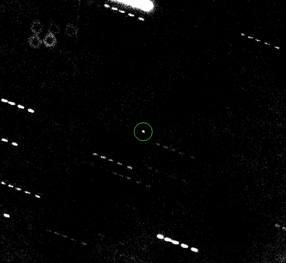 The potentially dangerous asteroid Apophis (circled) is seen here, in a composite of five exposures taken Jan. 31 by a telescope in Hawaii. The doughnut in the upper left corner is an artifact caused by a dust speck on the camera.