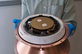 William Ailor, Director of the Center for Orbital and Reentry Debris Studies at The Aerospace Corporation holds a Re-entry Breakup Recorder to record spacecraft re-entry and breakups.
