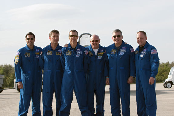 Space shuttle Endeavour's STS-134 crew members pose for a group photo on the Shuttle Landing Facility at NASA's Kennedy Space Center in Florida after arriving on March 29, 2011 to begin final launch training ahead of an April 19 liftoff.
