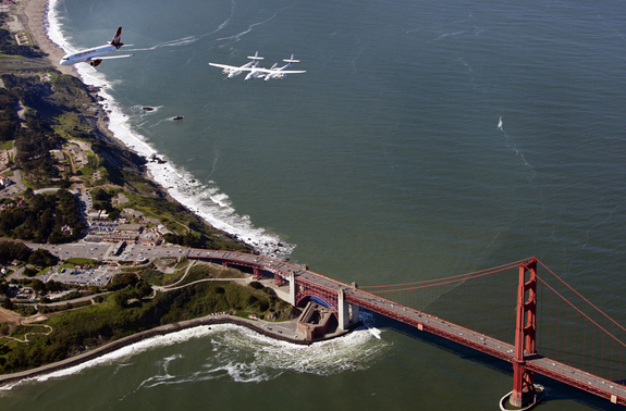 Virgin Galactic's private SpaceShipTwo spacecraft and its mothership WhiteKnightTwo flies over the Golden Gate Bridge with the Virgin America plane "My Other Ride is a Spaceship" on April 6, 2011 en route to open Terminal 2 at San Francisco International Airport.