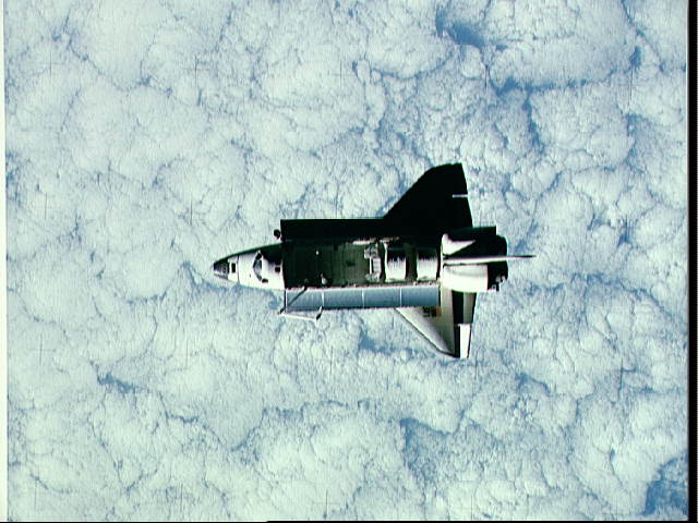 Cloud-covered Earth behind Challenger