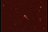 This is a visible-light image of GRB 110328A's host galaxy (arrow) taken on April 4 by the Hubble Space Telescope's Wide Field Camera 3. The galaxy is 3.8 billion light-years away.