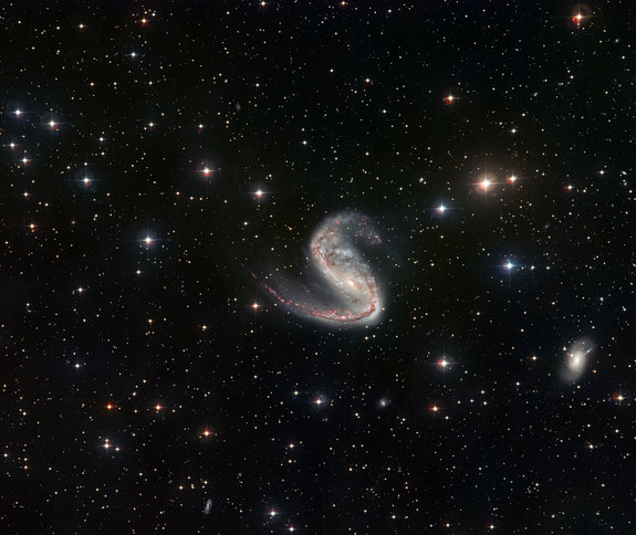 This picture of the Meathook Galaxy (NGC 2442) was taken by the Wide Field Imager on the MPG/ESO 2.2-metre telescope at La Silla, Chile. It shows a much broader view than the Hubble image, although less detailed. This view includes the whole galaxy and the surrounding sky, and clearly shows the asymmetric spiral arms.