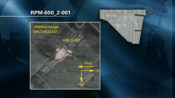 This NASA image shows the primary damaged tile on the space shuttle Endeavour that engineers are studying to determine whether any additional inspections or repairs are required while the shuttle is docked at the International Space Station during the STS-134 mission. This NASA image is from a May 19, 2011, briefing.