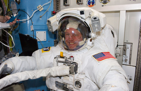 Wearing an Extravehicular Mobility Unit spacesuit, NASA astronauts Michael Fincke and Andrew Feustel (not visible), both STS-134 mission specialists, get prepared for the mission's second spacewalk onboard the International Space Station (ISS), on May 22, 2011 (Flight Day 7).
