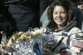 NASA astronaut Cady Coleman smiles and holds flowers presented to her after she and crewmates landed back on Earth on May 23, 2011. The Soyuz TMA-20 space capsule carrying Coleman and her two Expedition 27 crewmates landed in Kazakhstan to end their 157-day mission to the International Space Station.