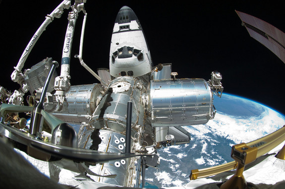 Parts of the International Space Station and docked shuttle Endeavour are featured in this image photographed by NASA astronaut Mike Fincke using a fish-eye lens attached to an electronic still camera, during the STS-134 mission's fourth and last spacewalk - the last EVA ever to be performed by a NASA shuttle crew on May 27, 2011.