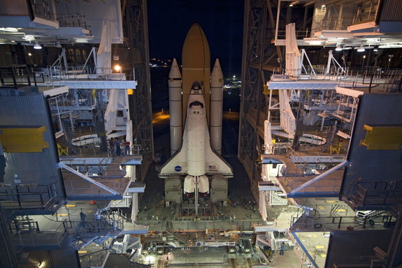 Space shuttle Atlantis, attached to its external fuel tank and solid rocket boosters atop a mobile launcher platform, slowly inches out of the Vehicle Assembly Building for the final time, on May 31, 2011.