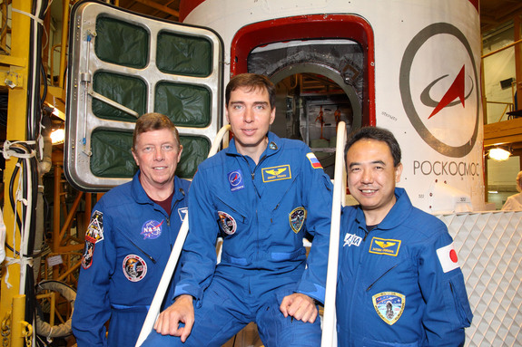 At the Baikonur Cosmodrome in Kazakhstan, NASA astronaut Mike Fossum (left), Expedition 28 flight engineer; cosmonaut and Soyuz commander Sergei Volkov (center) and Japan Aerospace Exploration Agency astronaut Satoshi Furukawa, flight engineer, pose for pictures outside their Soyuz TMA-02M spacecraft.