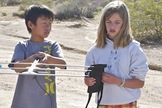 After having driven as far as possible, both on- and off-road, the DREAMS-11 payload recovery team conducts the final phase of its tracking operation on foot. Here Kenny Peng (l) and Lily Kelly use a Yagi-antenna radio beacon system and a road map of California to pinpoint the payload's landing site.