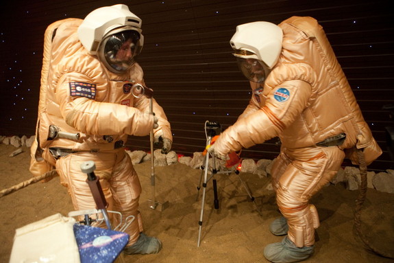Crew training for 'Marswalk' at the simulated martian terrain of the Mars500 experiment. The terrain, about 10 m long and 6 m wide, is covered with reddish sand and is built to resemble the surface at Gusev crater. On the ‘surface’, they conducted simulated scientific research by driving a rover and working with sensors to gather physical and chemical measurements.