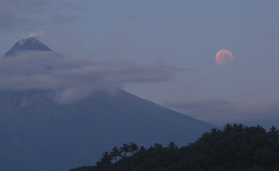 The total lunar eclipse of June 15, 2011 turns the moon a blood-red hue as steam rises from the Mayon volcano on Cagraray Island, Albay in the Philippines. Skywatcher David Matthews snapped this photo just before moonset during the eclipse.