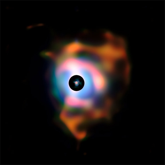 This picture of the dramatic nebula around the bright red supergiant star Betelgeuse was created from images taken with the VISIR infrared camera on ESO’s Very Large Telescope (VLT). This structure, resembling flames emanating from the star, forms because the behemoth is shedding its material into space.