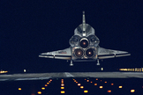 The space shuttle Endeavour glides back to Earth on Jan. 20, 1996, after nine days in space on the STS-72 mission. The orbiter is about to touch down on Runway 15 at the Shuttle Landing Facility at NASA's Kennedy Space Center in Cape Canaveral, Fla.