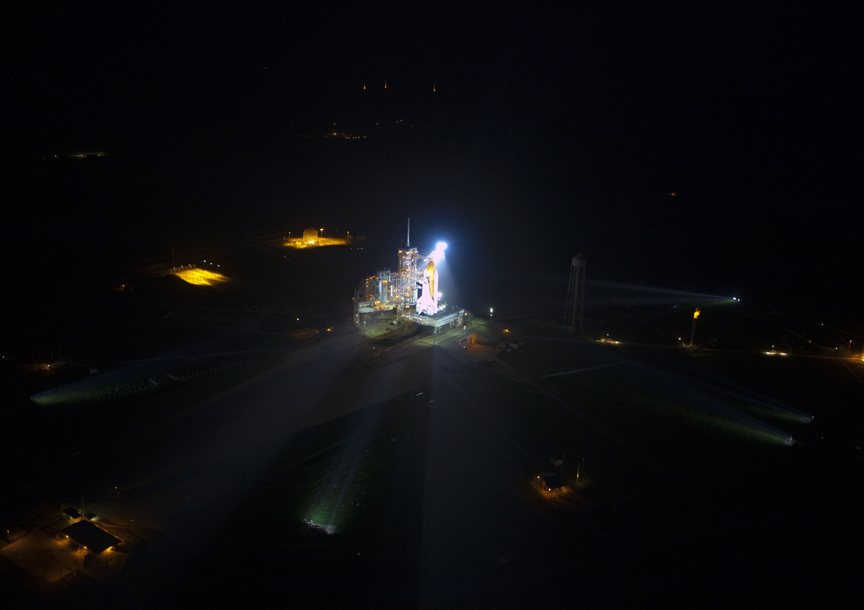Space shuttle Atlantis lit up on launch pad