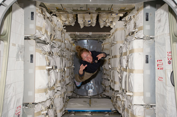NASA astronaut Sandy Magnus flies through the Rafaello module, filled to the brim with supplies, during the last space shuttle mission (STS-135) to the International Space Station.