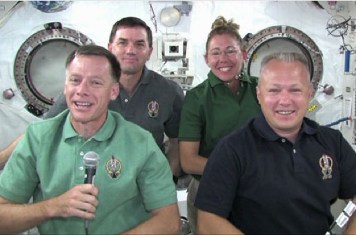The STS-135 crew gathers in the Kibo module of the International Space Station to talk to reporters Wednesday. From left to right are Commander Chris Ferguson, Mission Specialists Rex Walheim and Sandy Magnus and Pilot Doug Hurley.