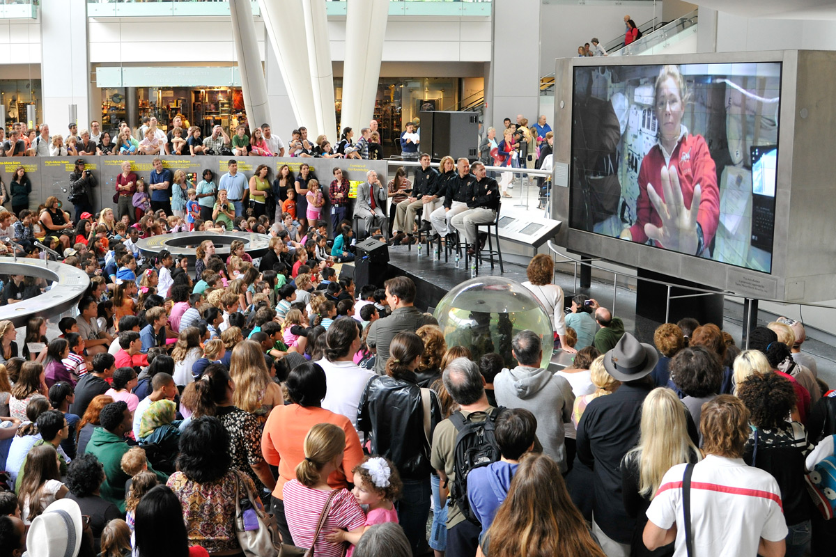 STS-135 Astronauts Watch Video Screen at American Museum of Natural History