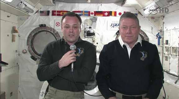 Space station astronauts Ron Garan (left) and Mike Fossum talk to reporters Sept. 6.