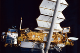 The Upper Atmosphere Research Satellite hangs in the grasp of the Remote Manipulator System against the blackness of space during deployment from Space Shuttle Discovery, September 1991.