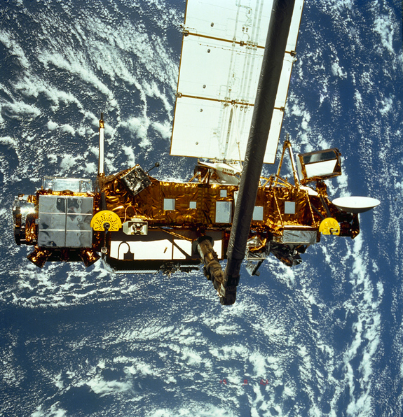 The Upper Atmosphere Research Satellite hangs in the grasp of the Remote Manipulator System during deployment from Space Shuttle Discovery, September 1991.