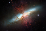 Plumes of glowing hydrogen blast from the center of M82, a well known galaxy undergoing a torrent of star formation. This mosaic of six images taken in 2006 by the Hubble Space Telescope is the sharpest ever obtained of the entire galaxy.