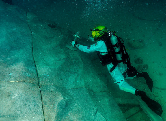 Steve Squyers maneuvers to an anchor point on "asteroid" rock wall during one of the extravehicular activities.