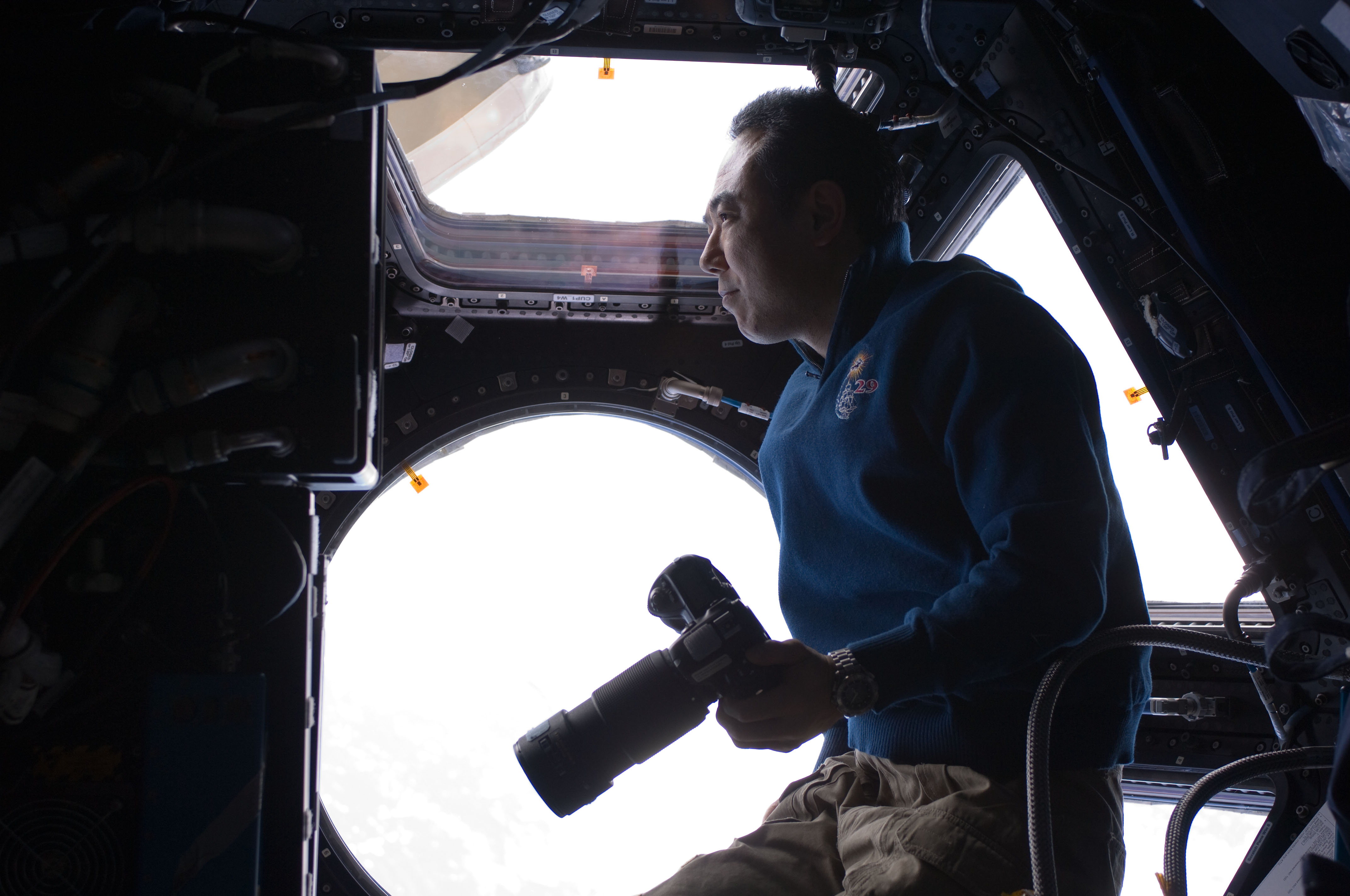 Satoshi Furukawa Holds a Still Camera in the ISS Cupola