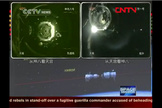 Chinese TV shows the Tiangong 1 module docking with the Shenzhou 8 spacecraft Nov. 2, 2011.